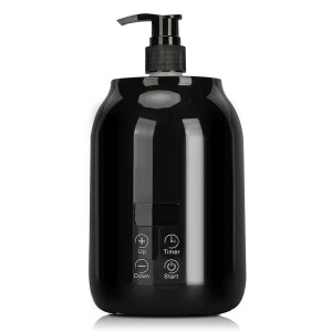 Scaldino elettrico per olio da massaggio con bottiglie di olio e imbuto